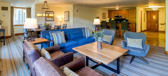 living room featuring hardwood / wood-style floors and an inviting chandelier