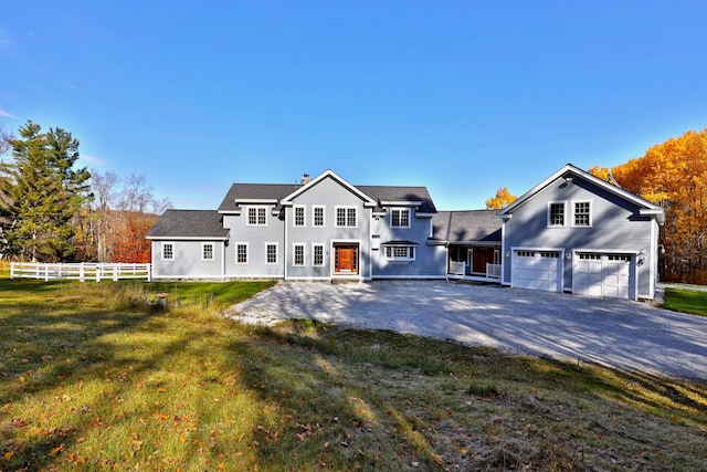 back of property with a patio area, a lawn, and a garage