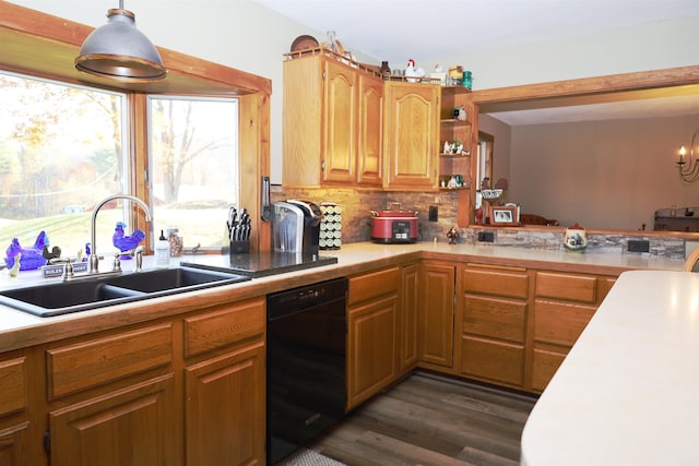 kitchen featuring black dishwasher, backsplash, dark hardwood / wood-style floors, sink, and decorative light fixtures