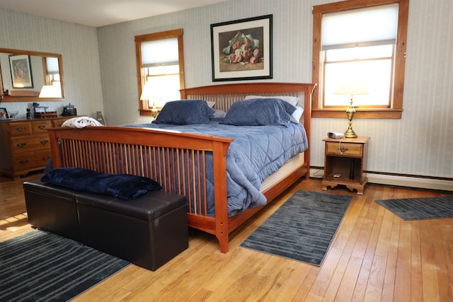 bedroom featuring wood-type flooring and baseboard heating