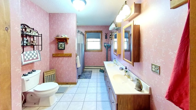 bathroom featuring toilet, vanity, tile patterned floors, and a baseboard radiator