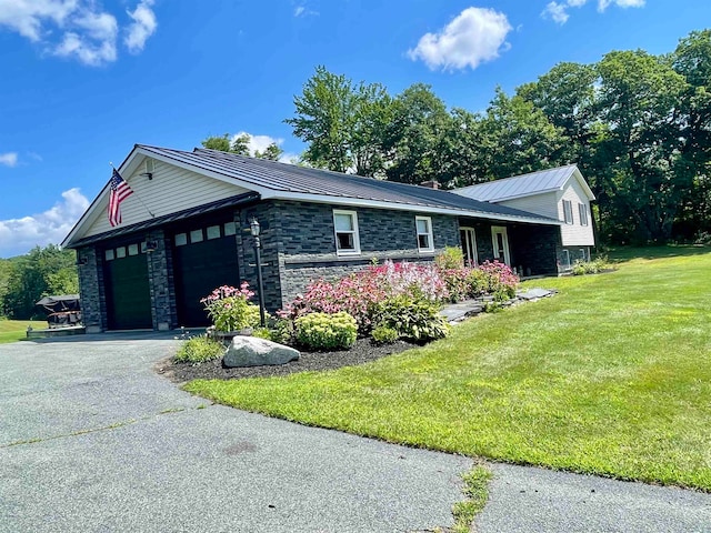 view of front of house with a front yard and a garage