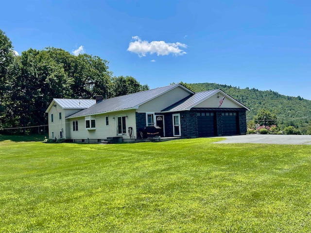 single story home with a garage and a front lawn