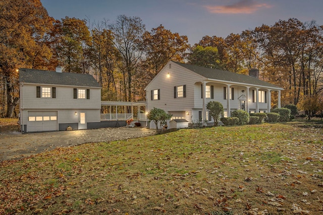 view of front of home featuring a yard and a garage