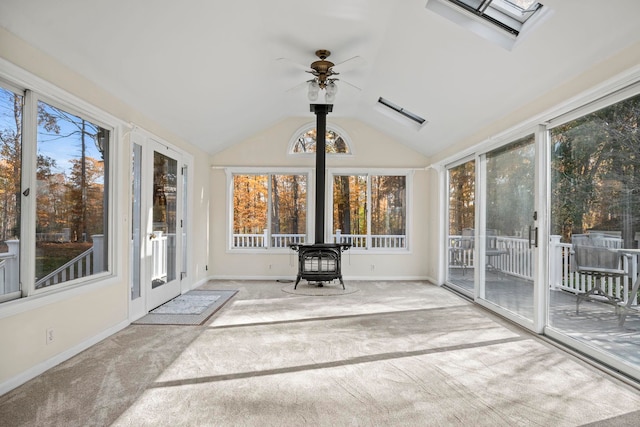 unfurnished sunroom featuring ceiling fan and vaulted ceiling with skylight