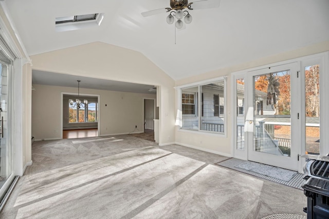 unfurnished living room with lofted ceiling, light carpet, and ceiling fan with notable chandelier