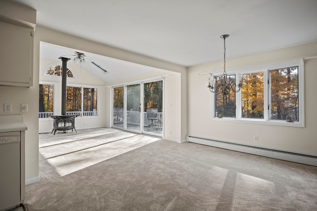 unfurnished living room featuring carpet flooring, ceiling fan with notable chandelier, a wood stove, vaulted ceiling, and baseboard heating