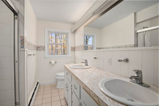 bathroom with a baseboard radiator, a shower with shower curtain, toilet, vanity, and tile patterned flooring