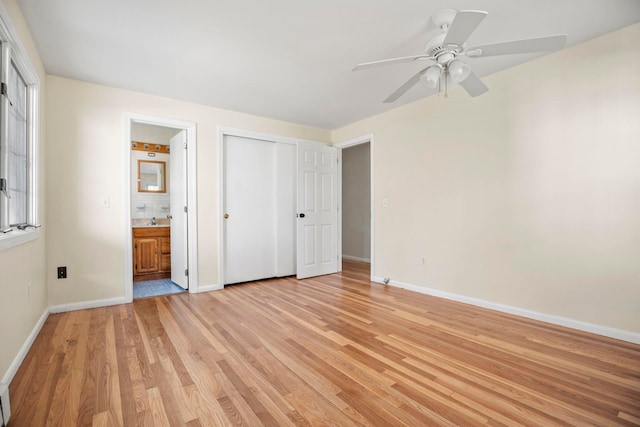 unfurnished bedroom with connected bathroom, ceiling fan, and light hardwood / wood-style flooring