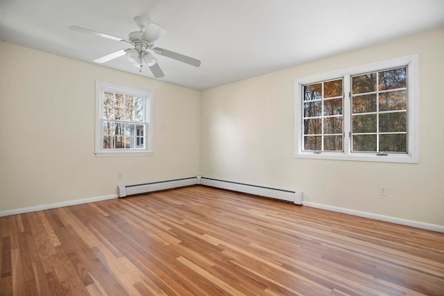 empty room with ceiling fan, a baseboard heating unit, and light wood-type flooring