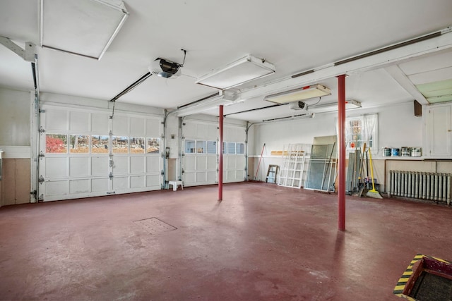 garage with a garage door opener and radiator