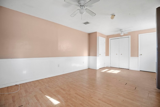 empty room with light hardwood / wood-style floors and ceiling fan