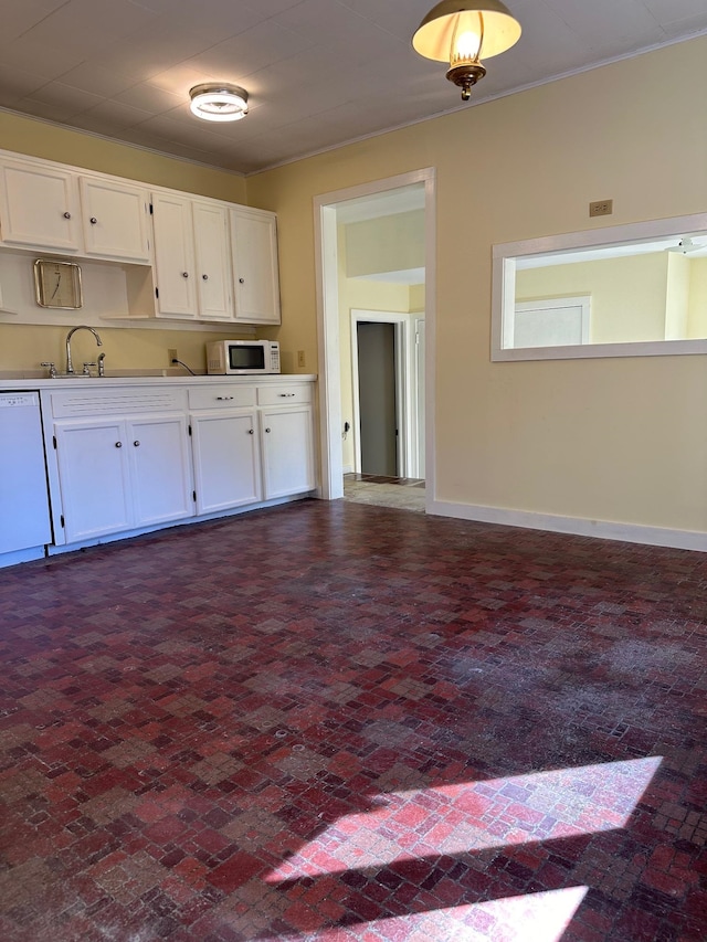 kitchen featuring white cabinets, white appliances, and sink