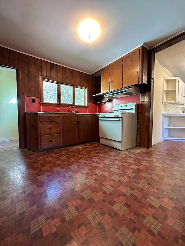 kitchen with wooden walls, sink, and white range