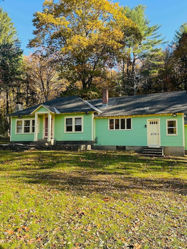 ranch-style home with a front lawn