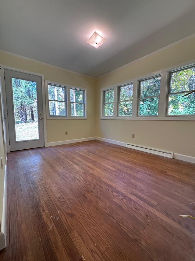 unfurnished room featuring hardwood / wood-style flooring and baseboard heating