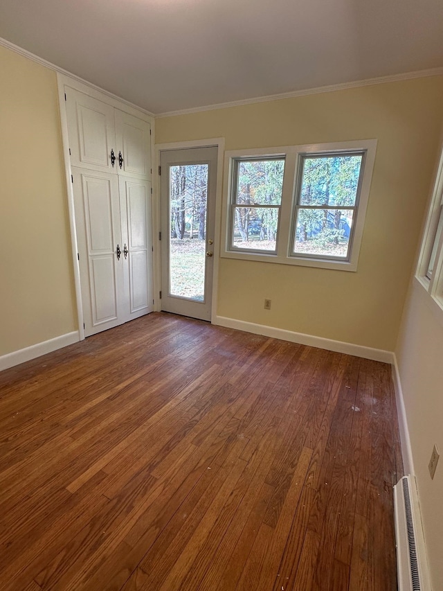 unfurnished room with ornamental molding and hardwood / wood-style flooring