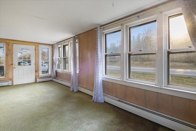 unfurnished sunroom with a baseboard radiator and a wealth of natural light