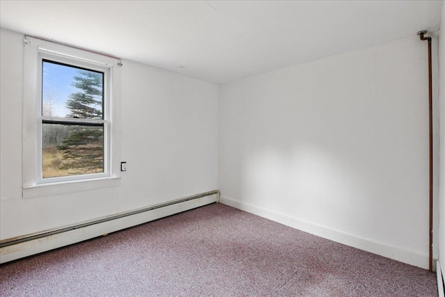 carpeted empty room with a baseboard heating unit