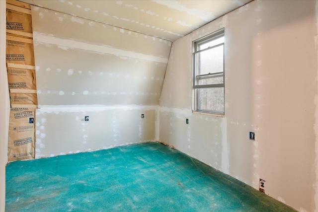 empty room featuring vaulted ceiling