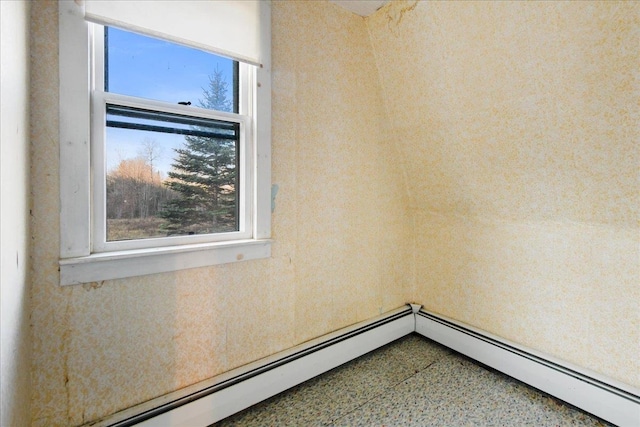 spare room featuring a healthy amount of sunlight and baseboard heating