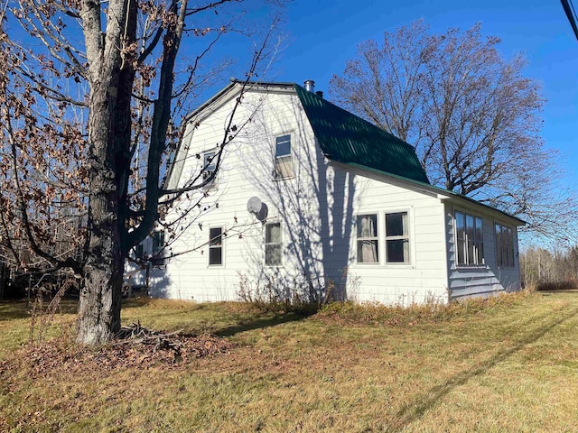 view of side of property with a yard