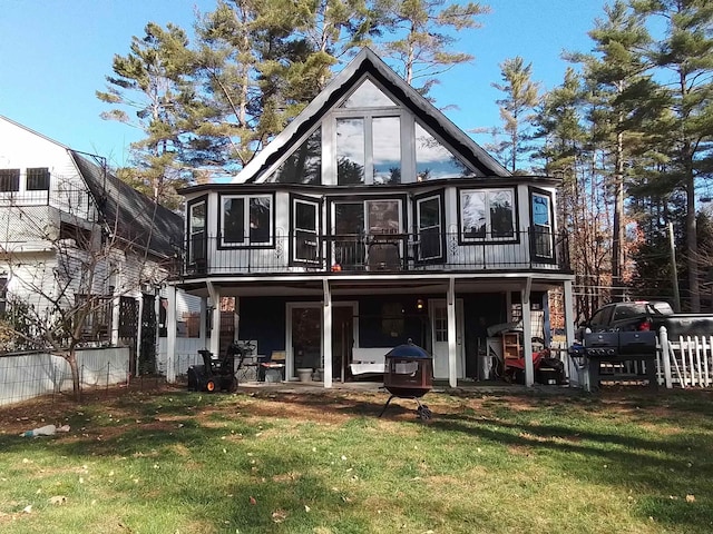 rear view of property with a yard and a sunroom