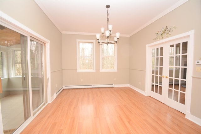 spare room with ornamental molding, light hardwood / wood-style flooring, a baseboard heating unit, and an inviting chandelier