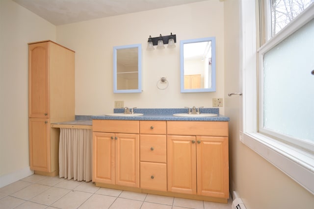 bathroom with vanity, a baseboard heating unit, and tile patterned floors