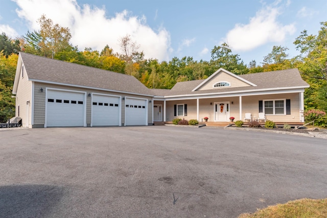 view of front of home featuring covered porch and a garage