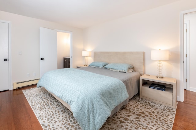 bedroom with wood-type flooring and a baseboard radiator