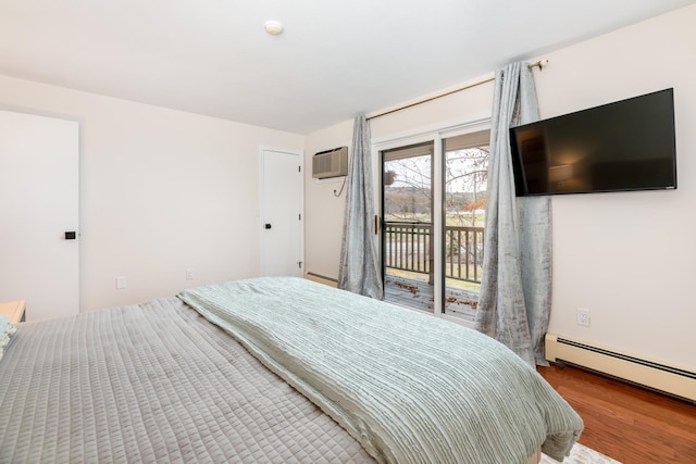 bedroom featuring access to outside, hardwood / wood-style floors, an AC wall unit, and a baseboard heating unit