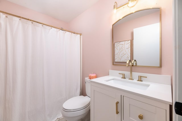 bathroom featuring vanity, curtained shower, and toilet