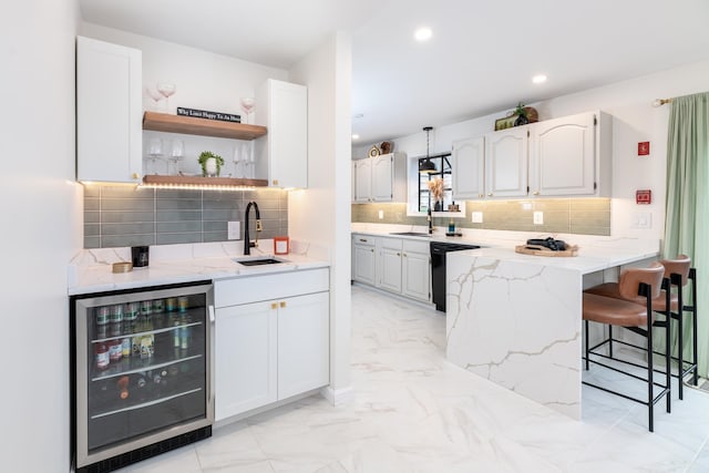 kitchen featuring white cabinetry, wine cooler, and a kitchen bar