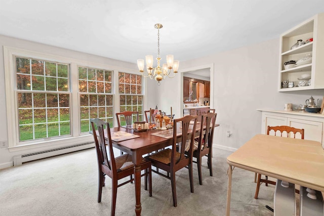 dining area with a chandelier, baseboard heating, and light colored carpet