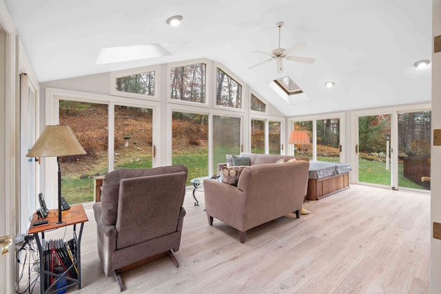 sunroom featuring vaulted ceiling with skylight and ceiling fan