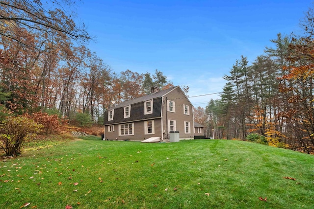 view of property exterior with a lawn