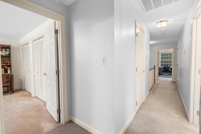 corridor featuring light colored carpet