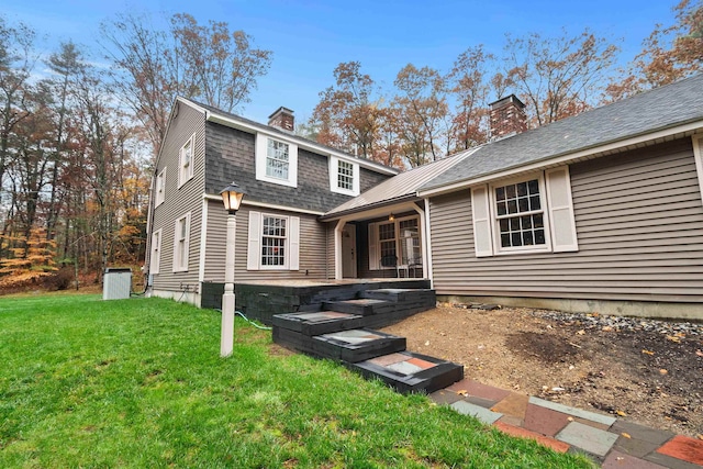 rear view of house with a yard