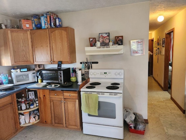 kitchen featuring ventilation hood, white appliances, and a textured ceiling