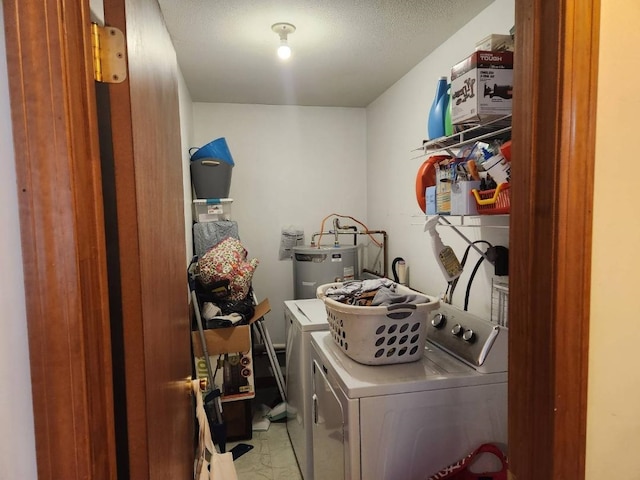 clothes washing area featuring washing machine and dryer and water heater