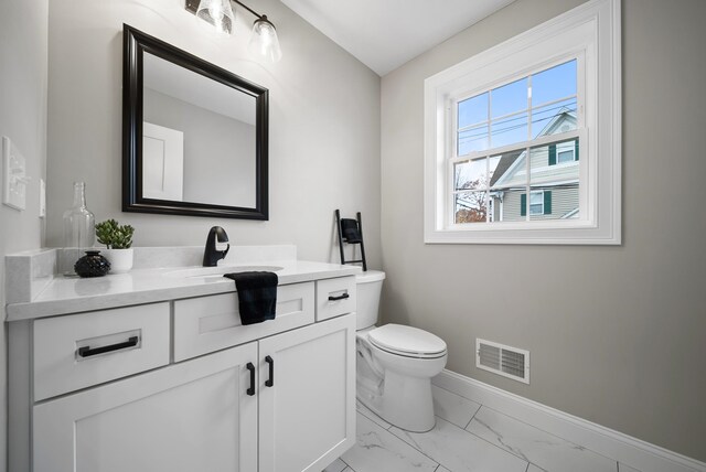 bathroom featuring vanity and toilet