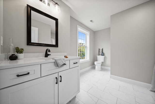 bathroom with vanity and toilet