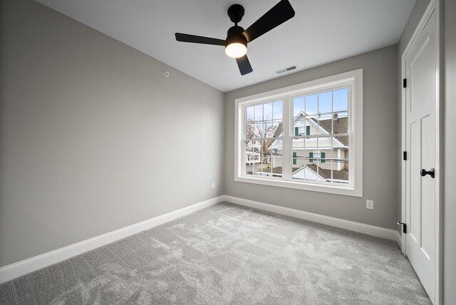 carpeted empty room with ceiling fan