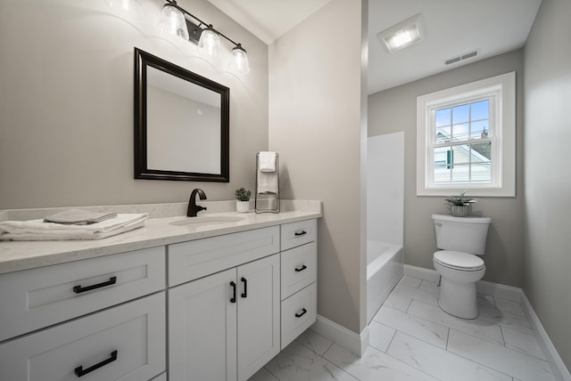 bathroom with vanity, toilet, and a tub