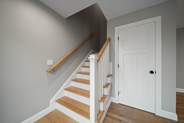 stairway featuring wood-type flooring