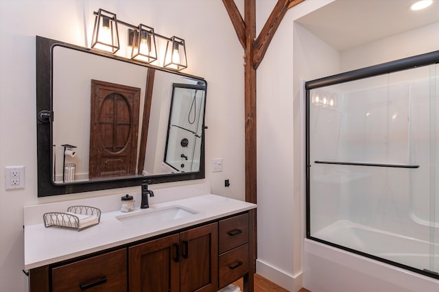 bathroom featuring vanity, combined bath / shower with glass door, and hardwood / wood-style flooring