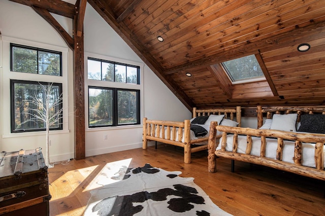 bedroom with a skylight, high vaulted ceiling, wooden ceiling, and light wood-type flooring