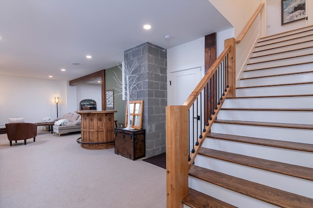 stairs featuring carpet flooring