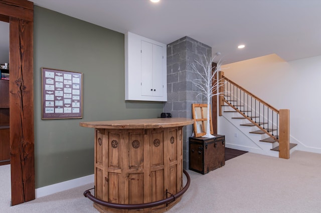 staircase featuring carpet